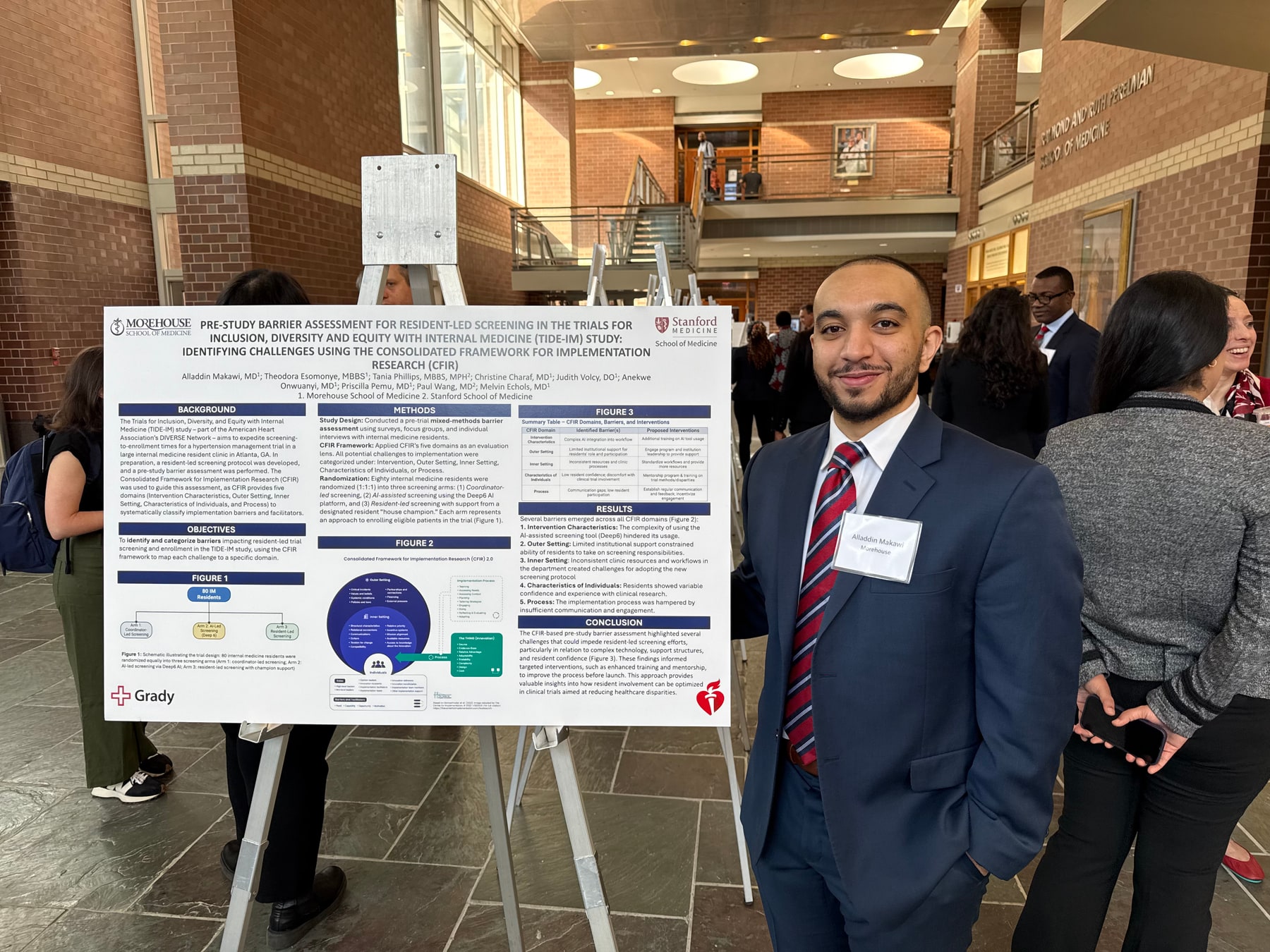 Alladdin Yousif Makawi, MD standing beside a research poster at the University of Pennsylvania